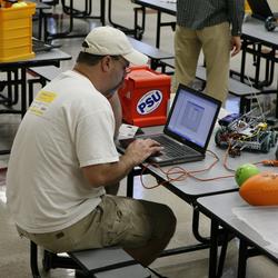 Ken writing code for his robot